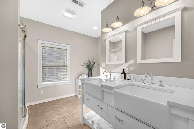 6836 NW Aarwood Trl, Rapid City, MI 49676 - full bath featuring a sink, baseboards, double vanity, and visible vents