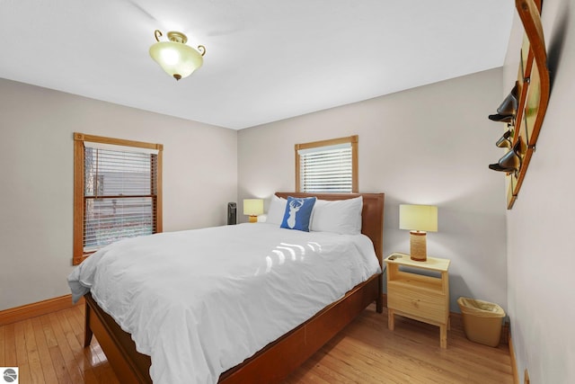 6836 NW Aarwood Trl, Rapid City, MI 49676 - bedroom with baseboards and light wood-type flooring