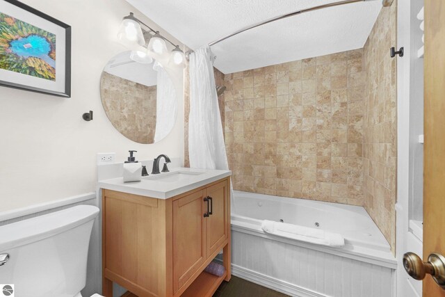 6836 NW Aarwood Trl, Rapid City, MI 49676 - bathroom featuring vanity, a combined bath / shower with jetted tub, and toilet