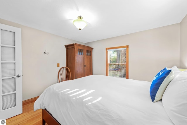 6836 NW Aarwood Trl, Rapid City, MI 49676 - bedroom with baseboards and light wood finished floors