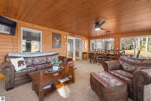 6836 NW Aarwood Trl, Rapid City, MI 49676 - carpeted living area featuring wooden ceiling, ceiling fan, and wood walls