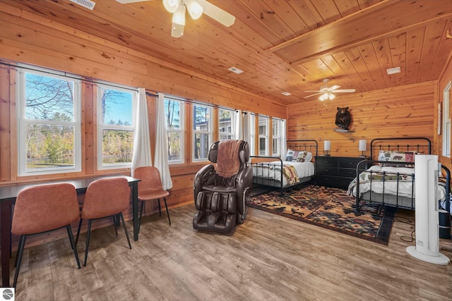 6836 NW Aarwood Trl, Rapid City, MI 49676 - bedroom with visible vents, wood walls, wood ceiling, and wood finished floors