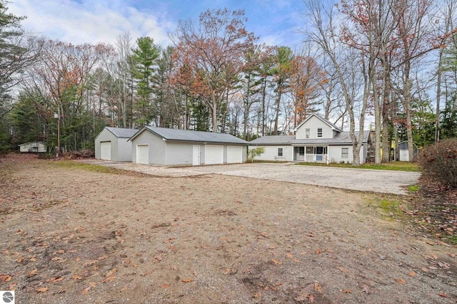 6836 NW Aarwood Trl, Rapid City, MI 49676 - exterior space with an outdoor structure and a garage