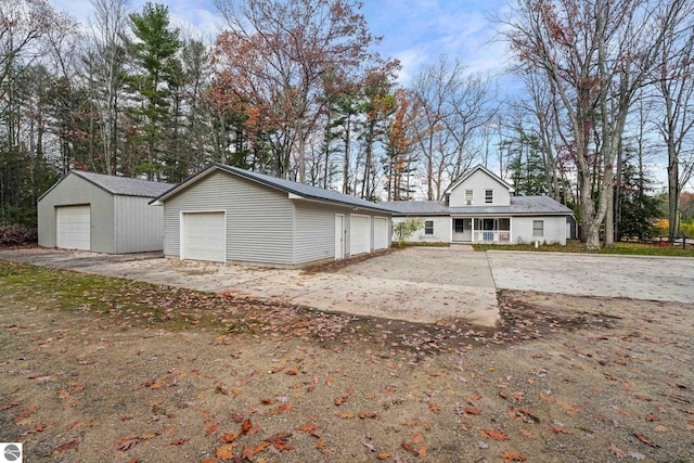 6836 NW Aarwood Trl, Rapid City, MI 49676 - view of front of home featuring a detached garage and an outdoor structure