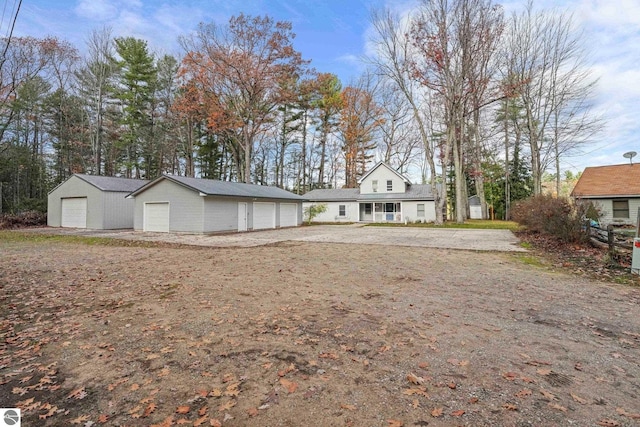 6836 NW Aarwood Trl, Rapid City, MI 49676 - view of front of property with an outbuilding and a detached garage