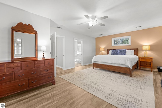 6836 NW Aarwood Trl, Rapid City, MI 49676 - bedroom with connected bathroom, baseboards, visible vents, and light wood-style flooring