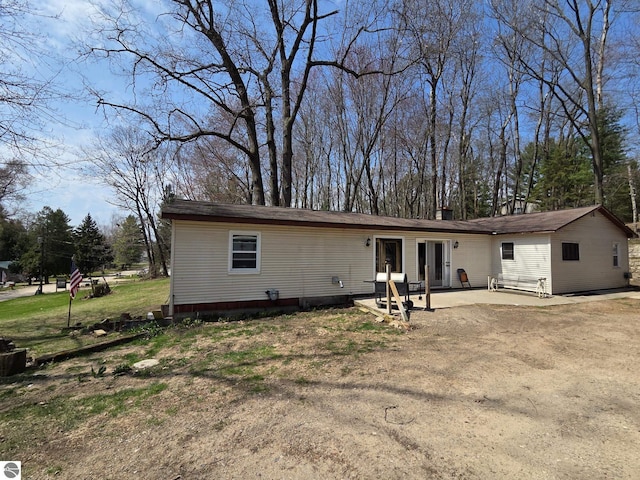 4280 Birch St, Lake, MI 48632 - view of front of house with a patio area and a chimney