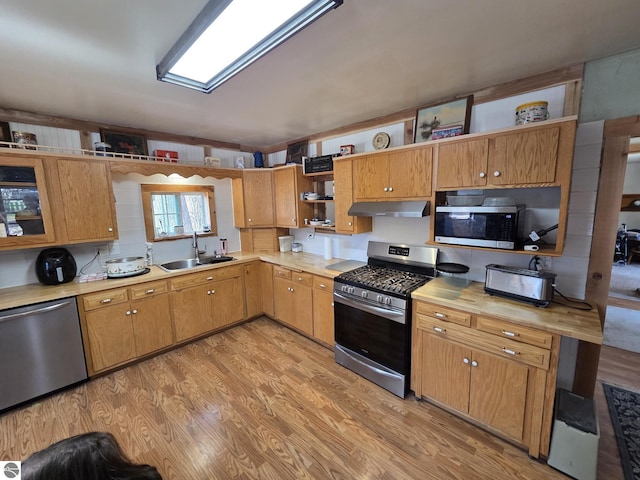 4280 Birch St, Lake, MI 48632 - kitchen with stainless steel appliances, open shelves, under cabinet range hood, a sink, and light wood-style flooring