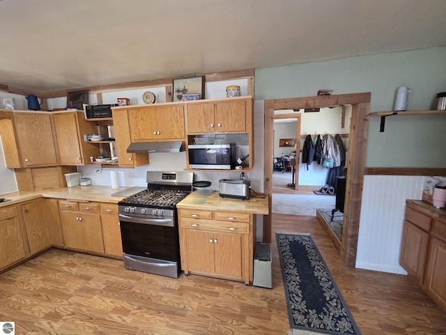 4280 Birch St, Lake, MI 48632 - kitchen with stainless steel appliances, under cabinet range hood, open shelves, light countertops, and light wood-style floors