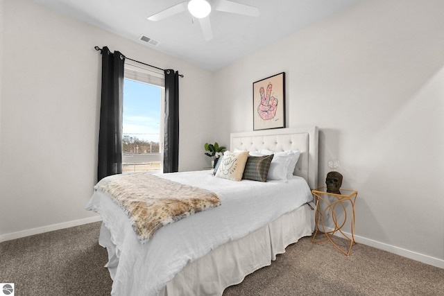 bedroom with baseboards, ceiling fan, dark carpet, and visible vents