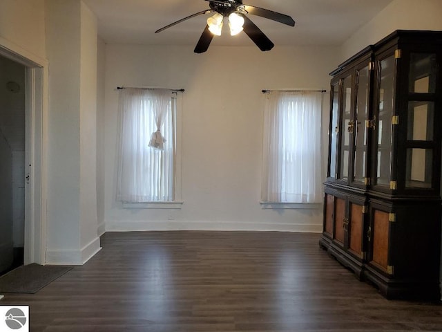 429 S Arnold, Mount Pleasant, MI 48858 - spare room featuring baseboards, a ceiling fan, and dark wood-type flooring
