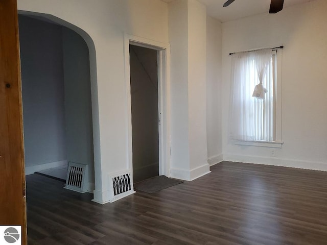 429 S Arnold, Mount Pleasant, MI 48858 - spare room featuring visible vents, a ceiling fan, dark wood-type flooring, and arched walkways