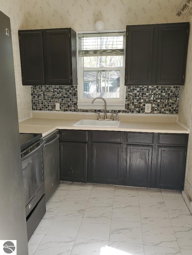 429 S Arnold, Mount Pleasant, MI 48858 - kitchen featuring light countertops, stainless steel appliances, a sink, and marble finish floor