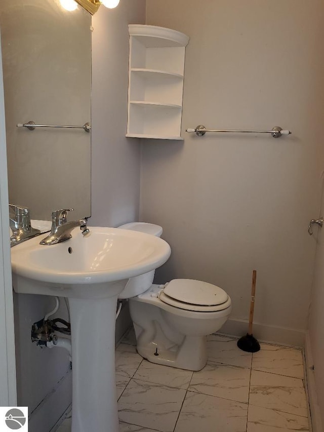 429 S Arnold, Mount Pleasant, MI 48858 - half bathroom featuring toilet and marble finish floor