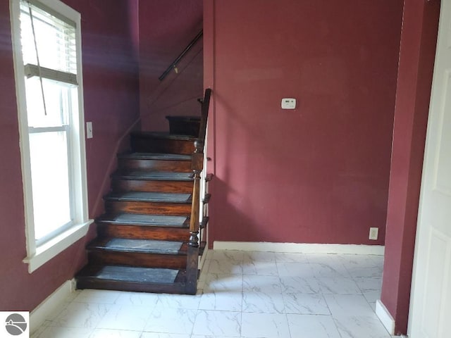 429 S Arnold, Mount Pleasant, MI 48858 - stairs with baseboards, plenty of natural light, and marble finish floor
