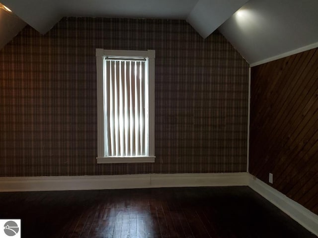 429 S Arnold, Mount Pleasant, MI 48858 - bonus room with baseboards, wallpapered walls, lofted ceiling, and hardwood / wood-style floors