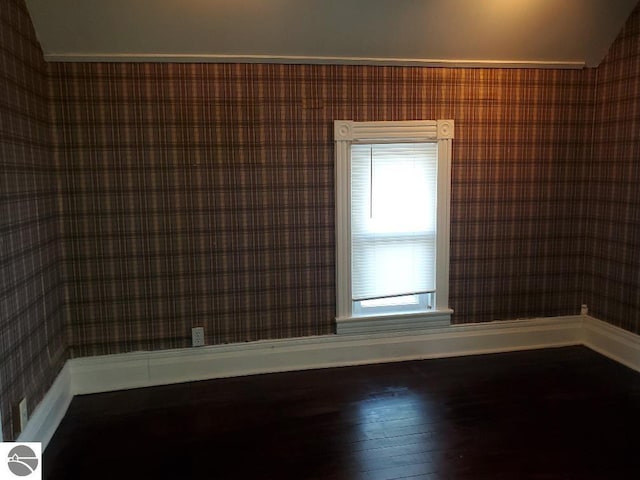 429 S Arnold, Mount Pleasant, MI 48858 - unfurnished room featuring baseboards, vaulted ceiling, and wallpapered walls