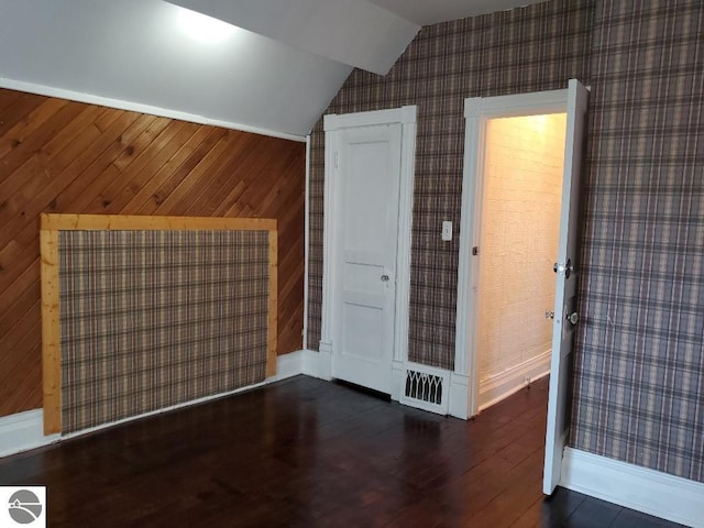 429 S Arnold, Mount Pleasant, MI 48858 - additional living space with baseboards, vaulted ceiling, wallpapered walls, and wood finished floors