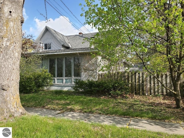 429 S Arnold, Mount Pleasant, MI 48858 - view of home's exterior featuring fence and a shingled roof