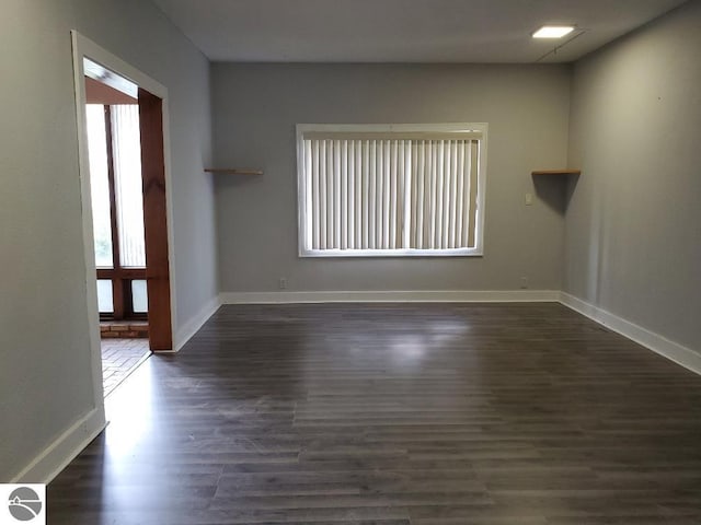 429 S Arnold, Mount Pleasant, MI 48858 - spare room featuring baseboards and dark wood-style flooring