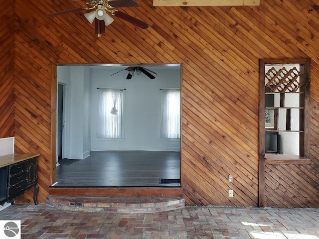 429 S Arnold, Mount Pleasant, MI 48858 - unfurnished room featuring wooden walls, ceiling fan, and brick floor