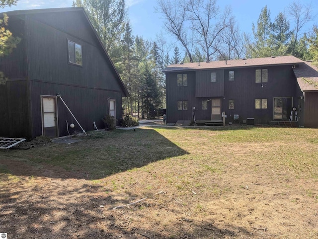 back of property with a lawn