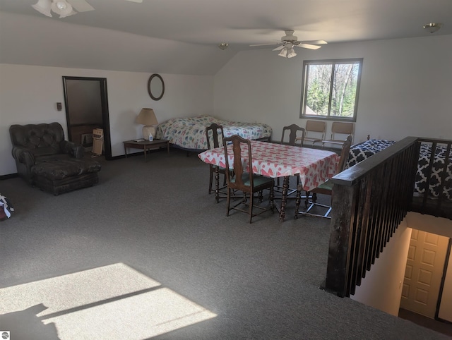 carpeted dining room featuring a ceiling fan and vaulted ceiling