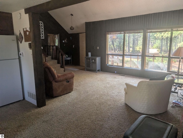 carpeted living room with visible vents, lofted ceiling, a wealth of natural light, and stairway