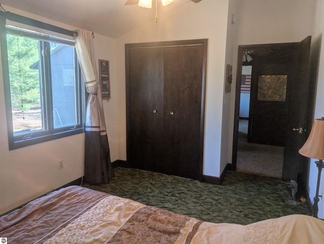 carpeted bedroom featuring vaulted ceiling, baseboards, a ceiling fan, and a closet