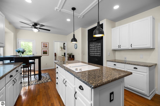 kitchen featuring a center island, white cabinets, dark wood-style flooring, and white electric stovetop