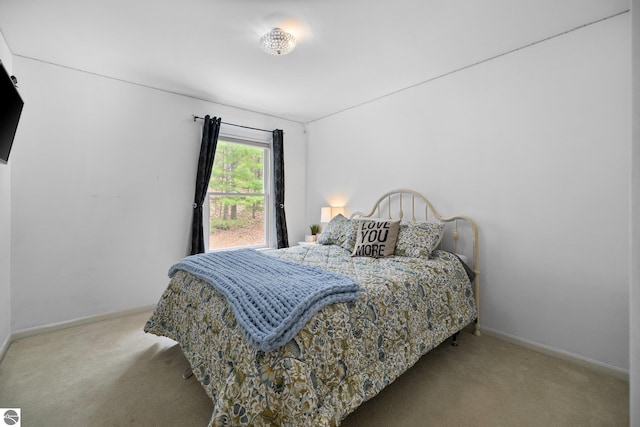 carpeted bedroom featuring baseboards