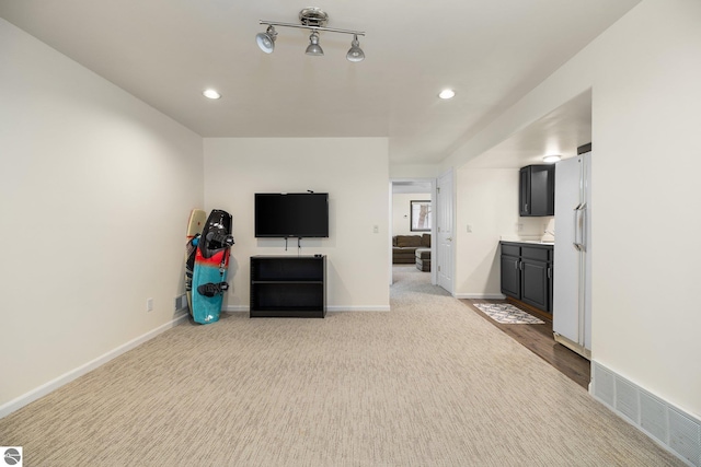 unfurnished living room with carpet flooring, recessed lighting, baseboards, and visible vents