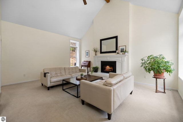 living room featuring light colored carpet, baseboards, a warm lit fireplace, and high vaulted ceiling