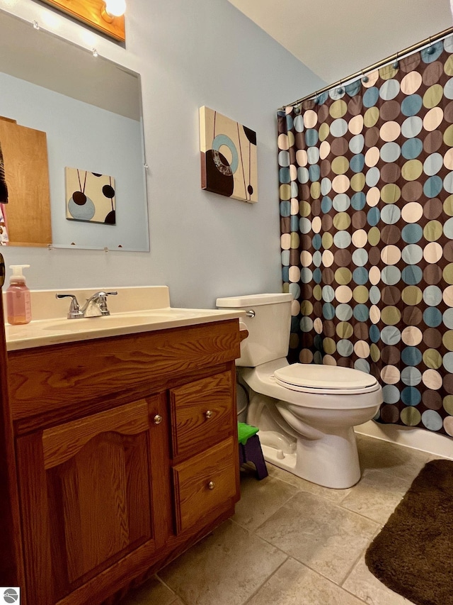 full bath with vanity, tile patterned floors, toilet, and a shower with shower curtain