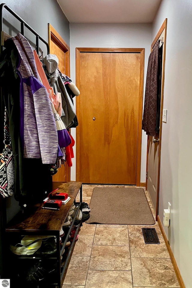 doorway featuring baseboards and visible vents