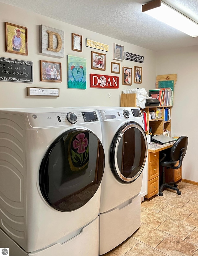 laundry room with stone finish floor, baseboards, laundry area, and washer and clothes dryer