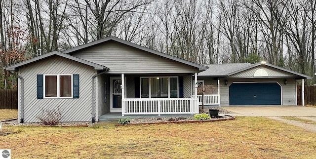 ranch-style house with fence, an attached garage, a porch, and a front yard