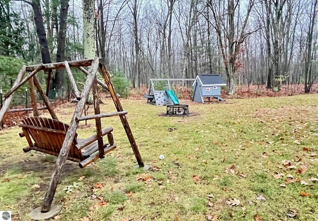 view of yard featuring a playground and an outdoor structure