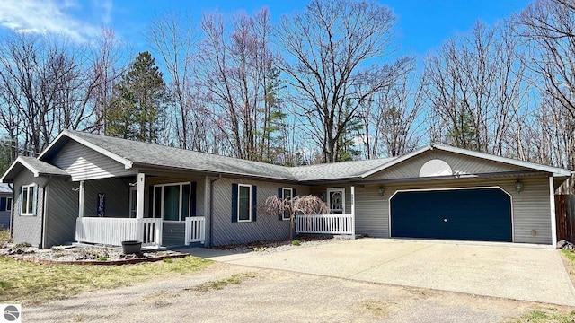 ranch-style home with a porch, an attached garage, and driveway