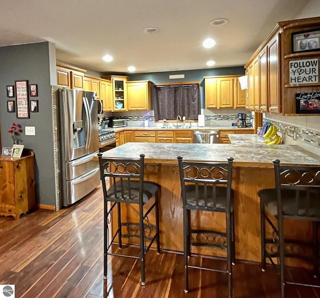 kitchen with a peninsula, open shelves, appliances with stainless steel finishes, and dark wood finished floors
