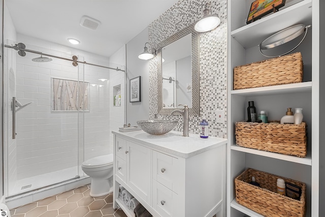 bathroom featuring visible vents, a shower stall, vanity, tile patterned floors, and toilet