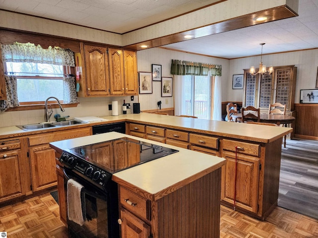 kitchen with a notable chandelier, a sink, a center island, a peninsula, and black appliances