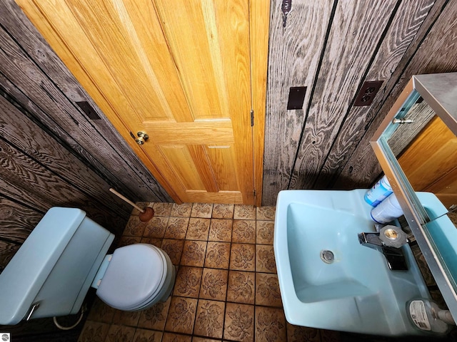 bathroom with toilet and tile patterned flooring