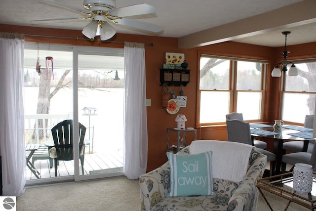 living room featuring ceiling fan and carpet