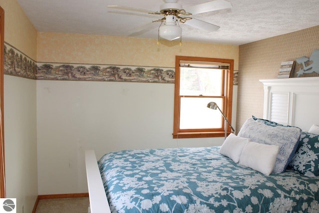 bedroom featuring carpet floors, a ceiling fan, and baseboards