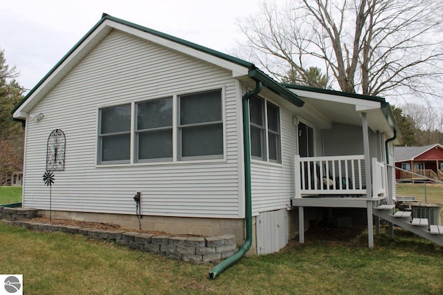 view of side of home featuring a lawn