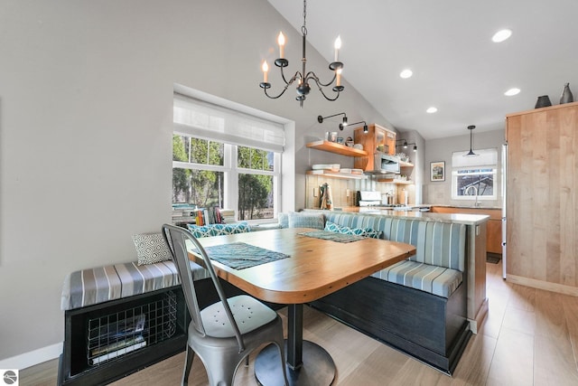 dining room featuring baseboards, recessed lighting, a notable chandelier, and a healthy amount of sunlight