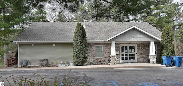 1508 Newport St Unit 10, Traverse City, MI 49686 - view of front of home with stone siding and a shingled roof