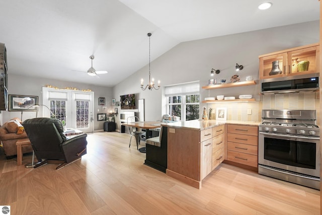 kitchen with appliances with stainless steel finishes, light brown cabinets, open floor plan, decorative backsplash, and light wood-type flooring