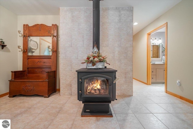 room details with baseboards, a wood stove, and recessed lighting